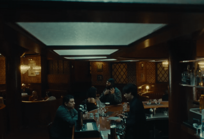 a group of people sitting at a table in a restaurant