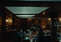 a group of people sitting at a table in a restaurant