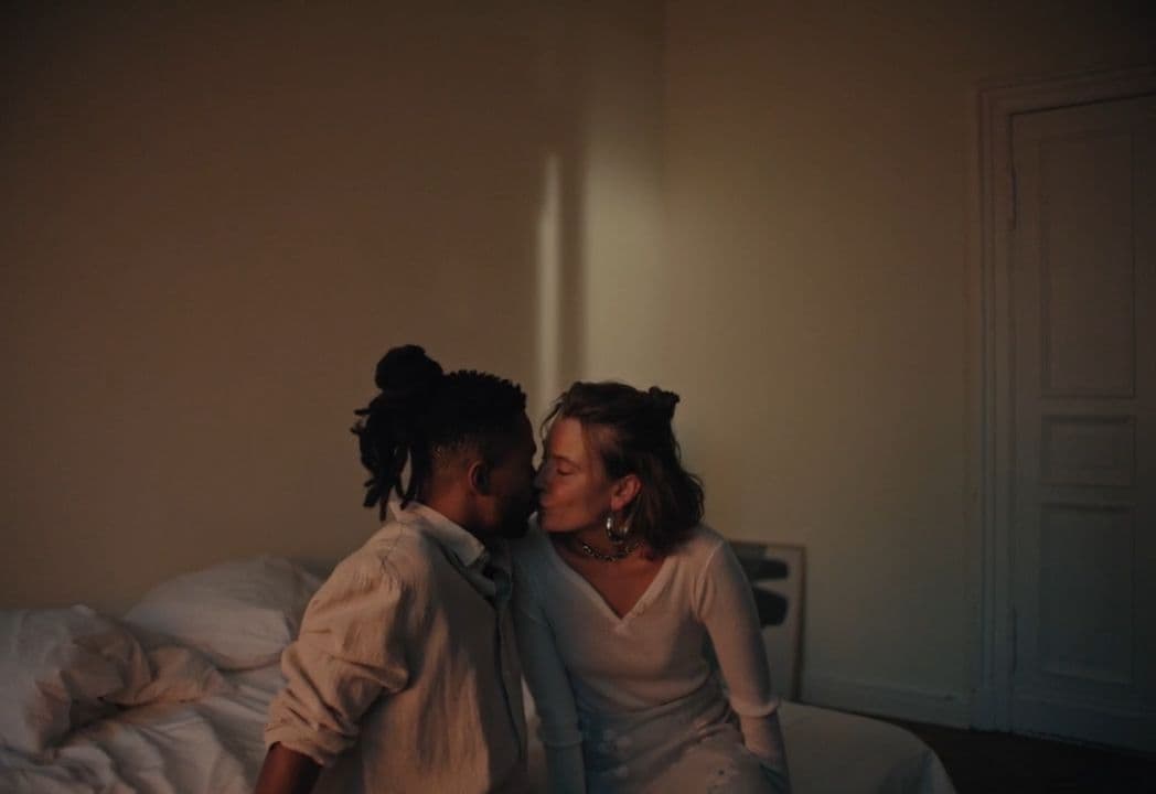 a couple of people that are sitting on a bed
