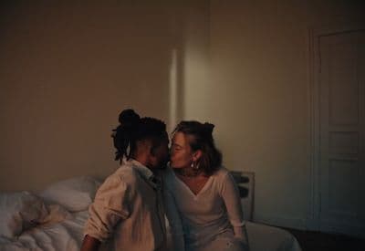 a couple of people that are sitting on a bed