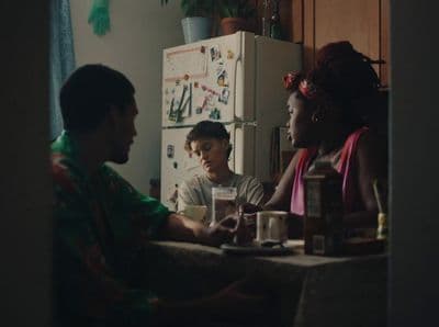 a group of people sitting around a kitchen table