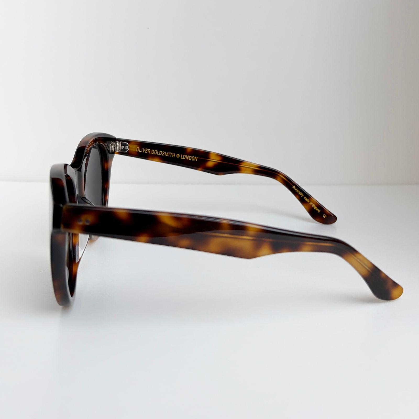 a pair of sunglasses sitting on top of a white table