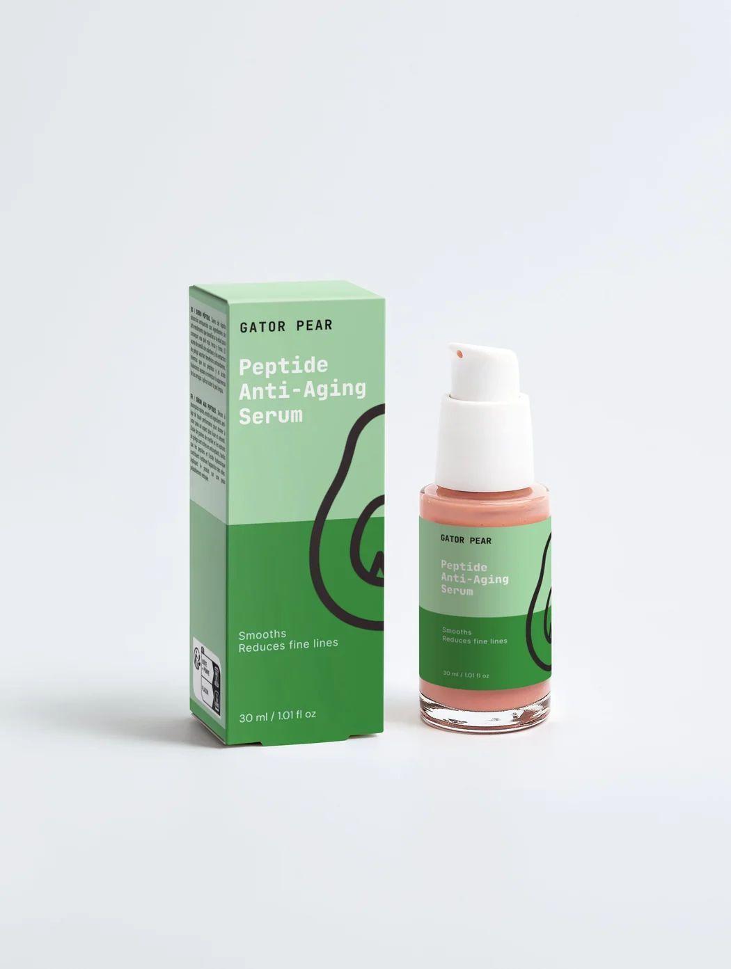 Studio product photo of a green Peptide Anti-Aging Serum box and pump bottle with pink serum on a white background.