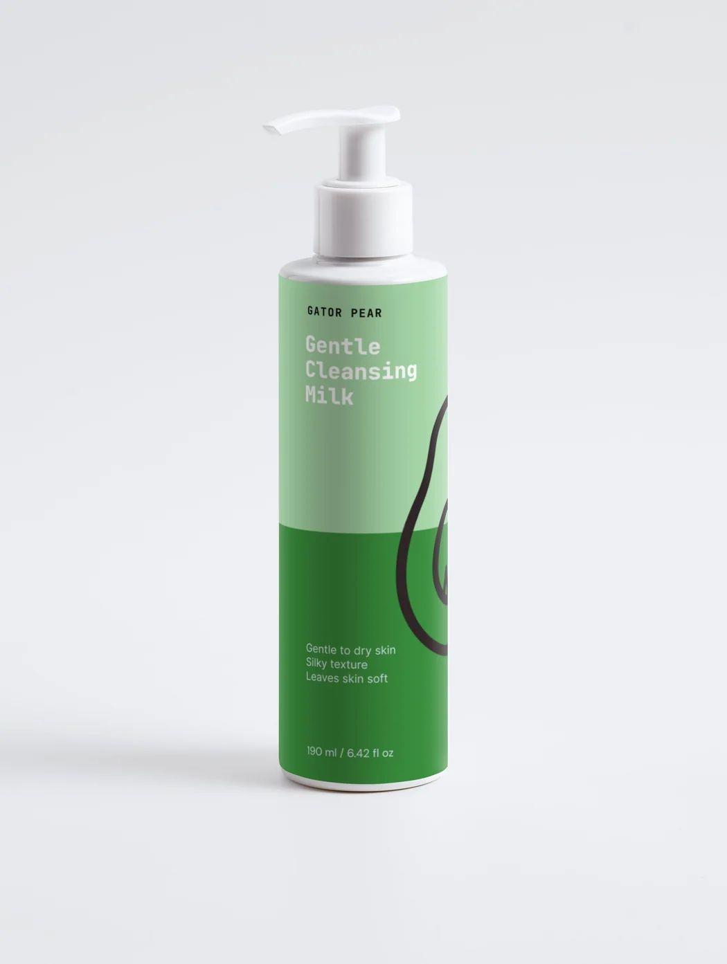 Green and white Gator Pear cleansing milk pump bottle photographed against a clean light gray studio background.