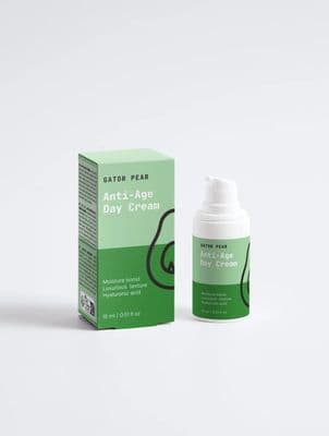 Green Gator Pear anti-age day cream bottle and matching cardboard box on a white studio background, minimalist skincare product photography.