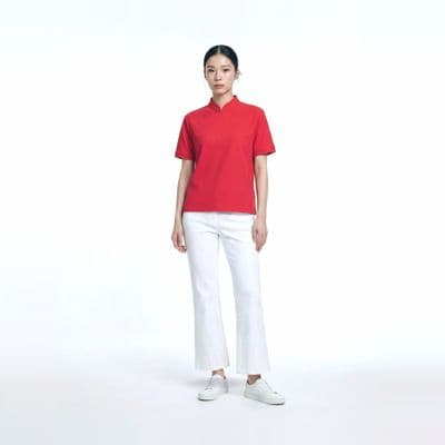 a woman in a red shirt and white pants