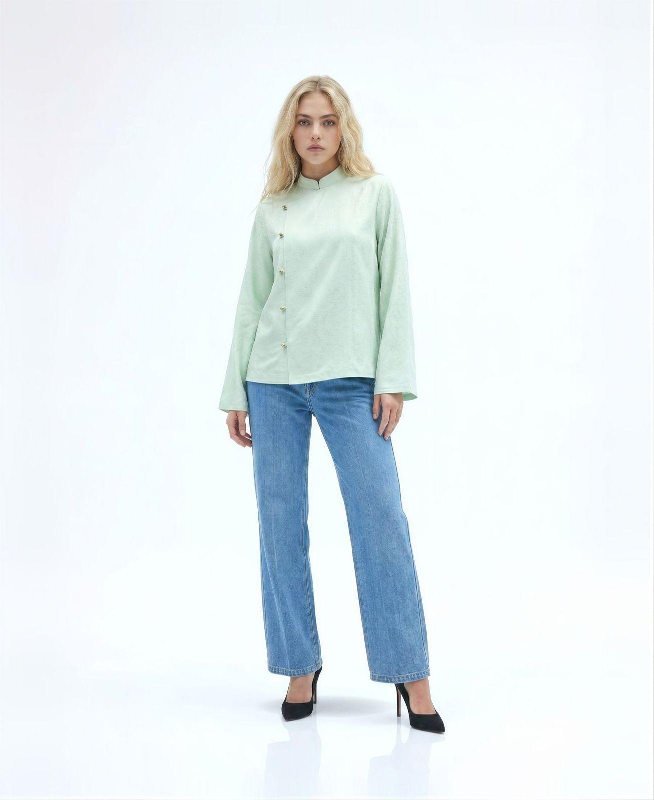 a woman wearing a green shirt and jeans