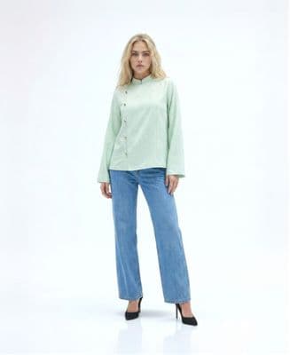 a woman wearing a green shirt and jeans
