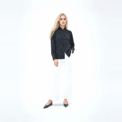 a woman in a black shirt and white pants