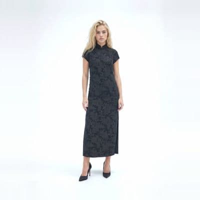 a woman in a black dress is posing for a picture