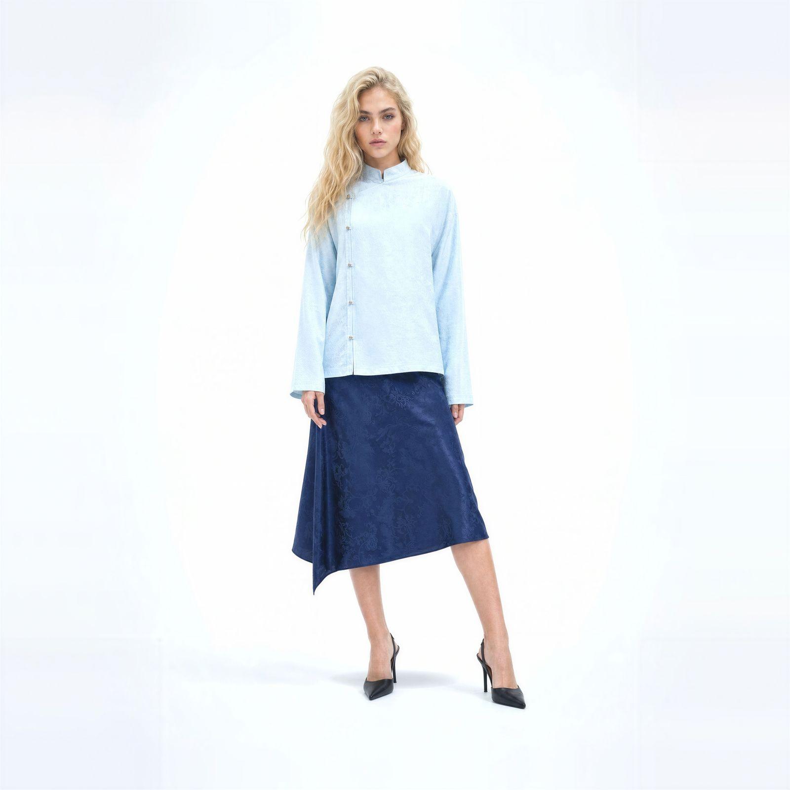 a woman in a blue shirt and a blue skirt