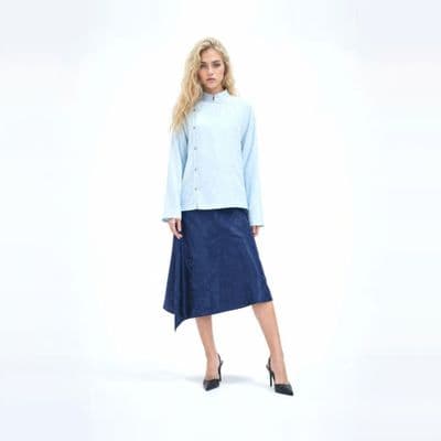 a woman in a blue shirt and a blue skirt
