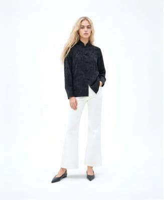 a woman in a black shirt and white pants