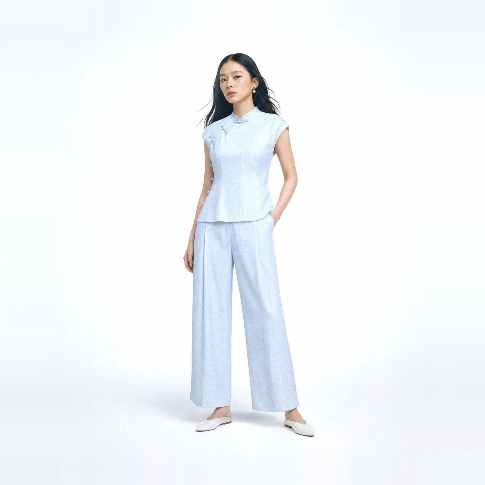 a woman in a white top and blue pants