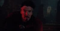 a man in a dark room with a red light
