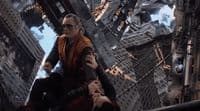 a man sitting on top of a tall building