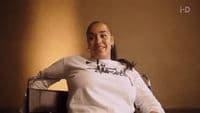 a woman sitting in a chair in a room