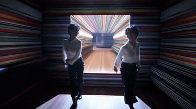 a couple of women standing next to each other in a room