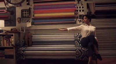 a woman sitting on top of a couch in a room