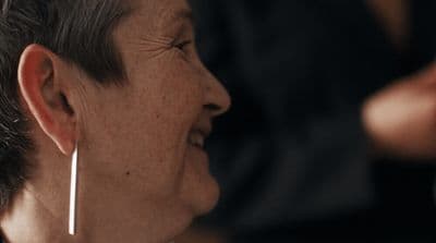 a close up of a person wearing earrings