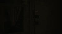 a dark room with a door and a window