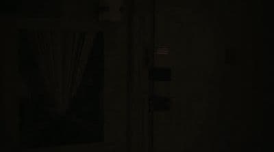 a dark room with a door and a window