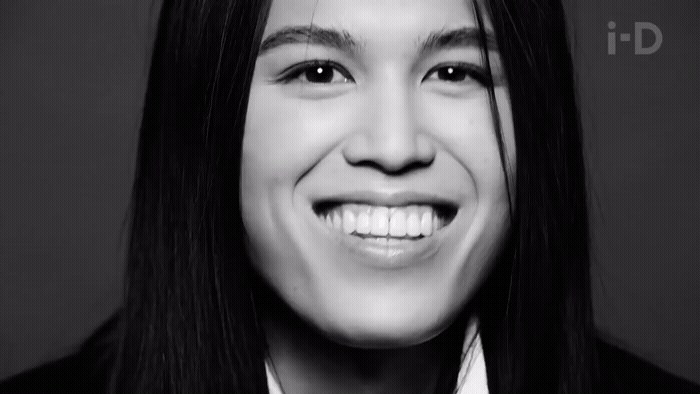a black and white photo of a smiling woman