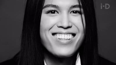 a black and white photo of a smiling woman