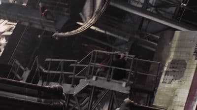 a man standing on top of a metal structure