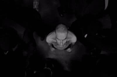 a man sitting in the middle of a group of people
