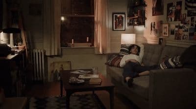 a person laying on a couch in a living room