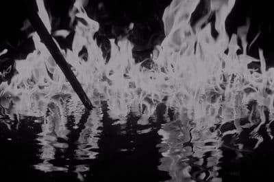 a black and white photo of fire and water