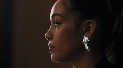 a close up of a person wearing earrings