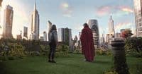 a couple of people standing on top of a lush green field