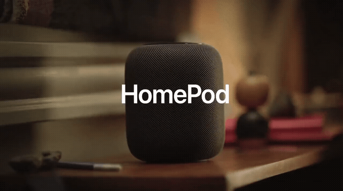 a home pod sitting on top of a wooden table