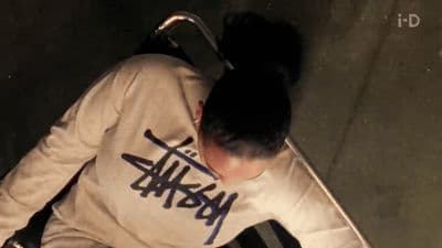 a man in a white shirt with graffiti on his shirt