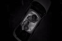 a man laying in a bathtub in the dark