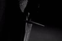 a black and white photo of a person holding a knife