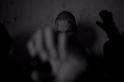 a black and white photo of a person's hand reaching for something
