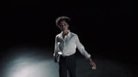 a woman in a white shirt and black pants