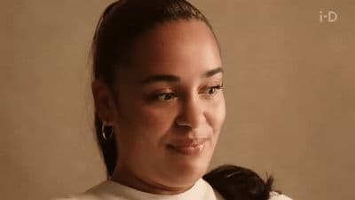a woman with a ponytail is smiling at the camera