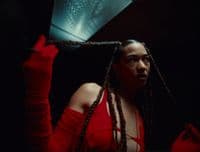 a woman with dreadlocks holding a umbrella
