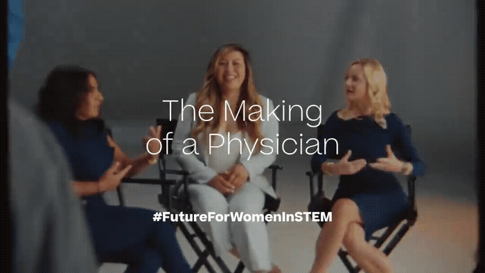 a group of women sitting in chairs talking to each other