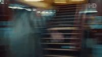a blurry photo of a person walking down a set of stairs
