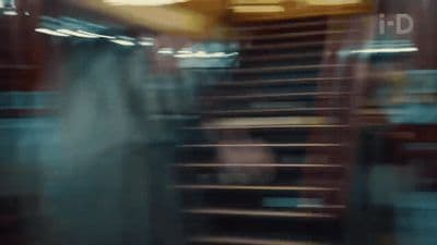a blurry photo of a person walking down a set of stairs