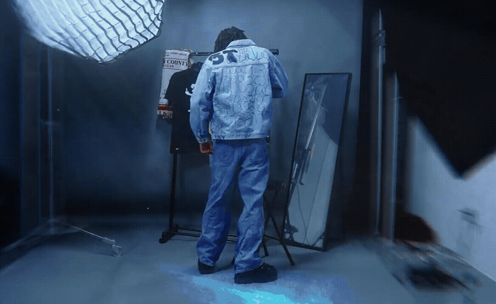 a man standing in front of a mirror in a room