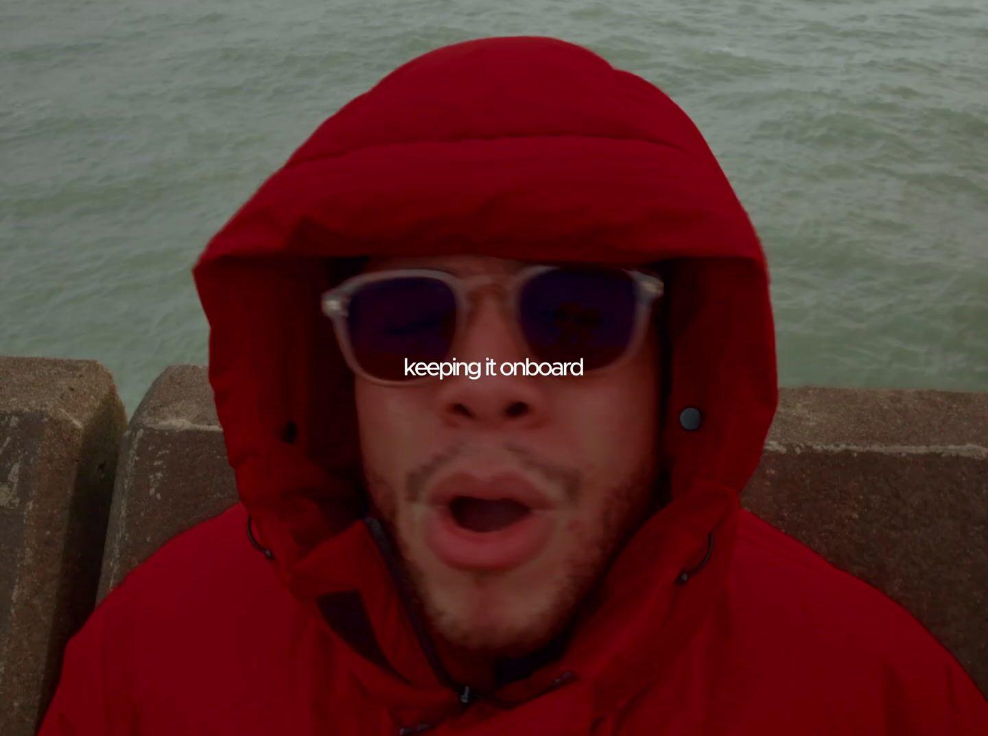 a man wearing sunglasses and a red jacket