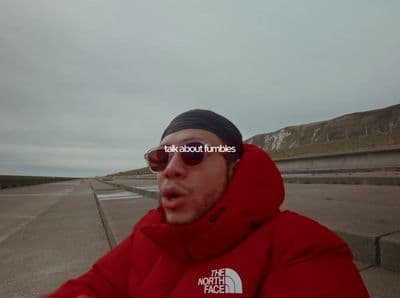 a man wearing sunglasses and a red jacket