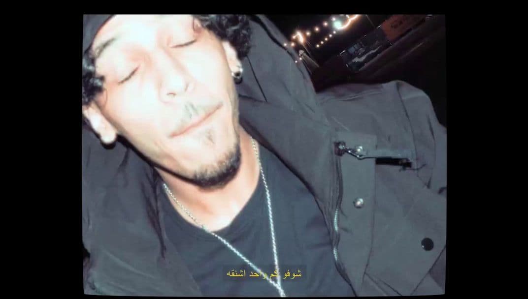 a man with his eyes closed wearing a black shirt