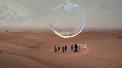 a group of people standing on top of a desert
